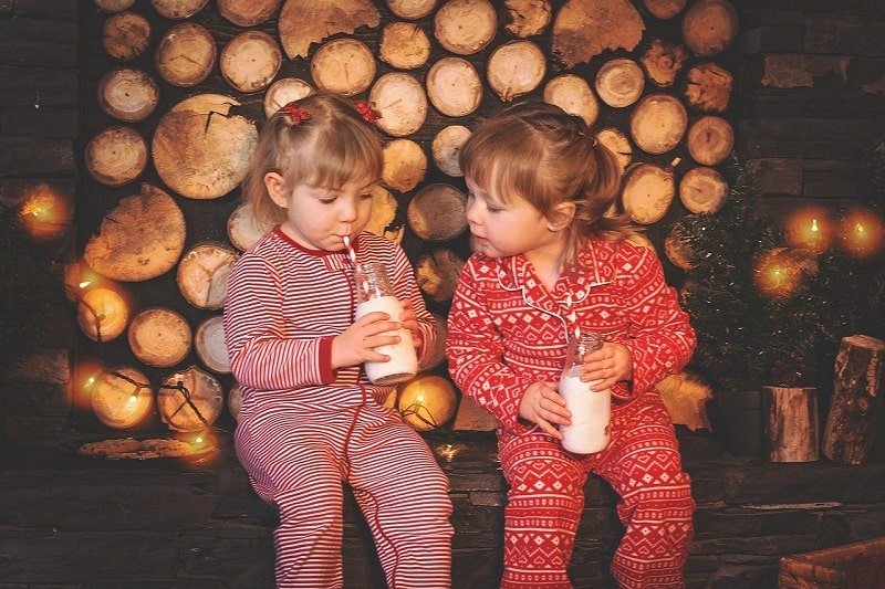 zwei kleine Mädchen im Schlafanzug trinken Milch