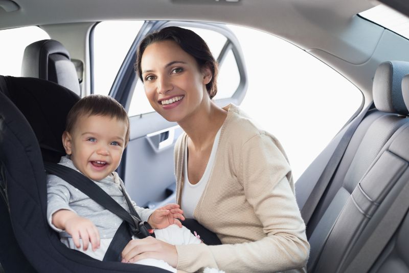 Mutter-sichert-ihr-Baby-im-Autositz