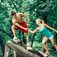 Fitness Trail Paar überquert Hindernis
