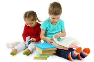 Kleine Kinder mit Büchern isoliert auf weiß